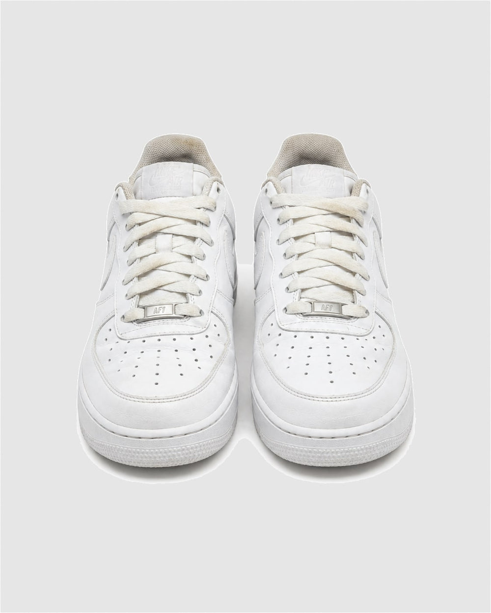 A pair of Triple White Nike Air Force 1s seen from the front